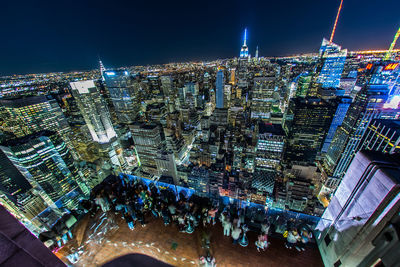 High angle view of illuminated buildings in city at night