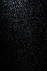 Full frame shot of raindrops on black background