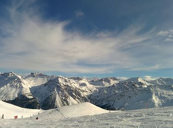 Scenic view of snow covered mountains against sky