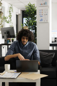 Young woman using laptop at office