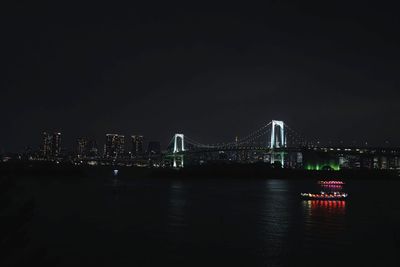 Illuminated city at waterfront