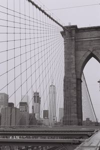 Low angle view of bridge in city against sky