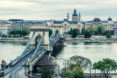 High angle view of chain bridge over danube river in city against cloudy sky