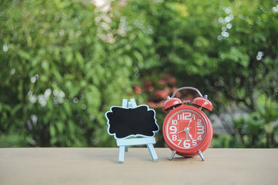 Alarm clock and board on table