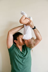 Father with son against white background