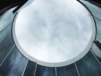 Low angle view of sky seen through modern building