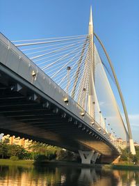 Low angle view of bridge over river against sky