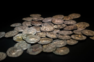 Close-up of coins on black background