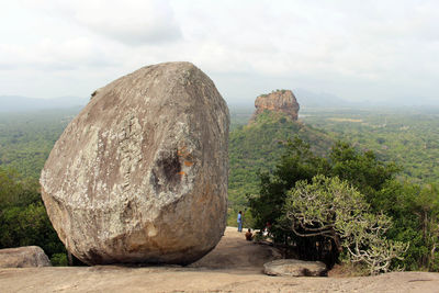 Panoramic view of rocks on landscape against sky