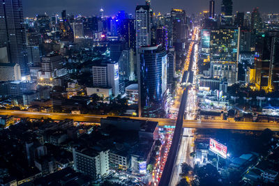 High angle view of illuminated city street and buildings at night