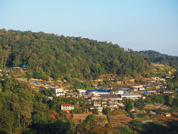 High angle view of trees and buildings against sky