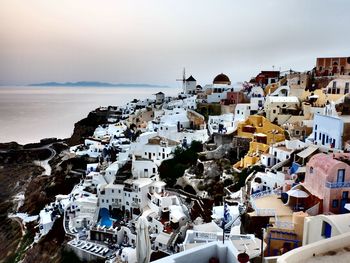 High angle view of townscape by sea against sky