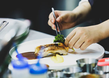 Midsection of person preparing food