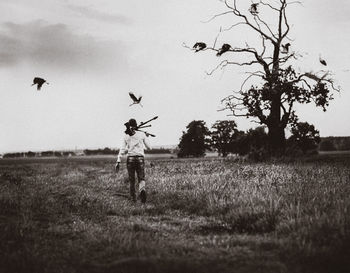 Man standing on field against sky