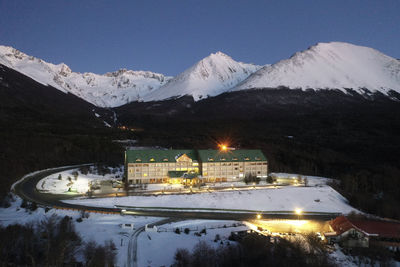 Scenic view of snowcapped mountains against sky at night