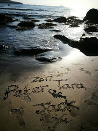 Text on sand at beach