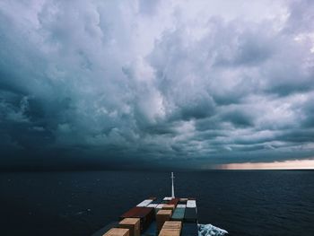 Scenic view of sea against storm clouds