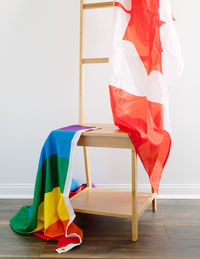 Flags on wooden chair against wall