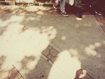 Low section of people walking on street