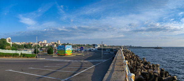 Panoramic view of city by sea against sky