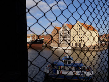 Buildings seen through chainlink fence