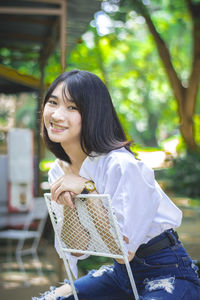 Young woman sitting outdoors