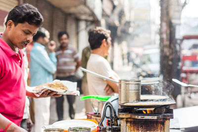 Man preparing thosai in market