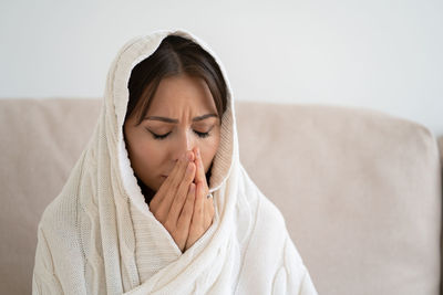 Close-up of depressed woman praying at home