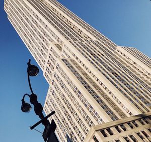 Low angle view of modern building against clear blue sky