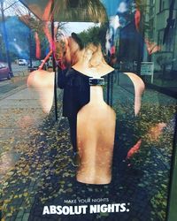 Close-up of woman with reflection in mirror