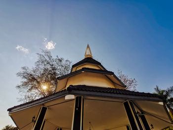 Low angle view of building and trees against sky