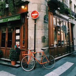 Bicycle parked on footpath by restaurant