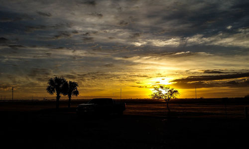 Silhouette of landscape against cloudy sky