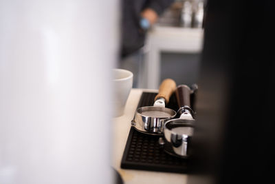 Banner of asian barista tamping the portafilter and preparing cup of coffee