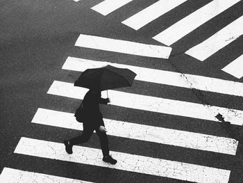 Low section of woman walking on street