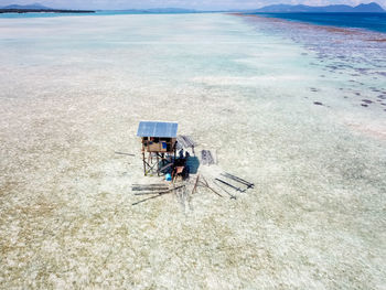 High angle view of construction of a small hut sitting on beach