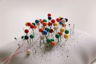 Close-up of multi colored candies against white background