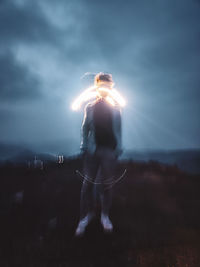 Rear view of man standing against sky