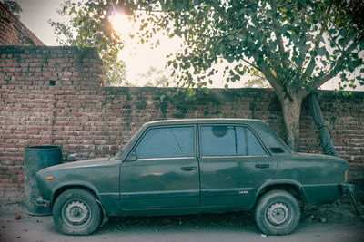 Old vintage car on street against wall