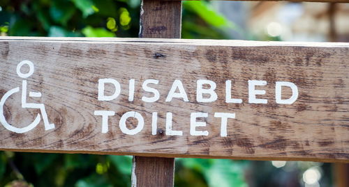 Close-up of sign on wooden plank