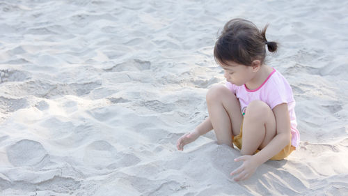 Side view of boy playing at beach