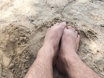 Low section of man relaxing on land