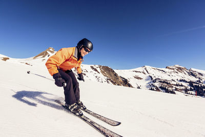 Austria, damuels, woman skiing in winter landscape