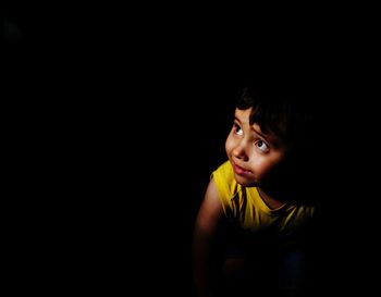 Cute child against black background