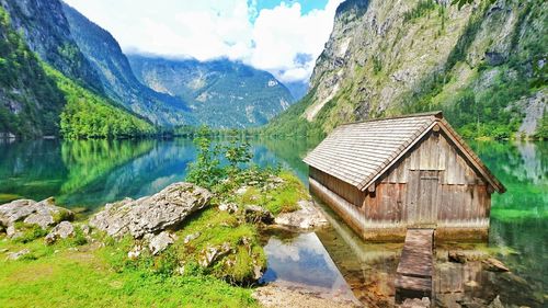 Scenic view of lake with houses in background