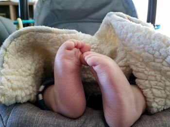 Close-up of baby feet in crib