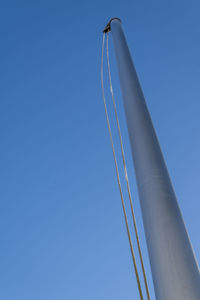 Flagpoles on a cold sunny winter day against a blue clear sky