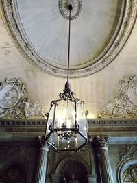 Low angle view of electric lamp on ceiling in building