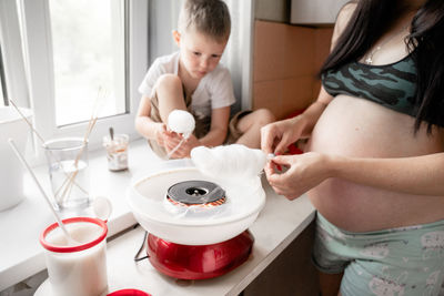 High angle view of mother holding baby at home