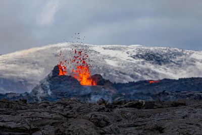 Scenic view of an volcano and snowcapped mountains 